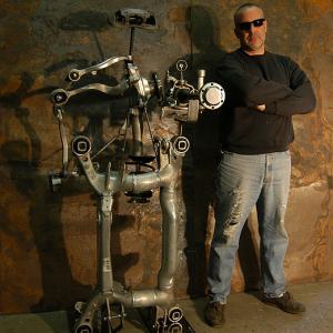 Sculptor Bruce Gray with his Robot sculpture made from a crashed BMW.