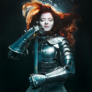 PADI-certified diver Virginia Hankins modeling underwater in armor