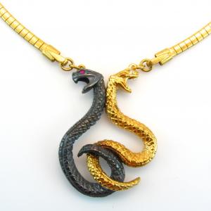 Hand carved dual good and evil intertwining snakes necklace designed and created by Heidi Metal Design for the TV pilot Scruples.