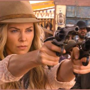 On left of Charlize Theron in A Million Ways to Die in the West