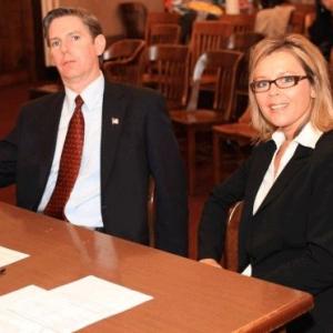 Still image of Jodie Shultz and T Arnold as District Attorney and Assistant District Attorney on the set of The Alibi