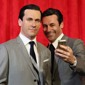Actor Jon Hamm takes a selfie as he unveils Don Draper's wax figure during Mad Men's Final Season at Madame Tussauds New York on May 9, 2014 in New York City.