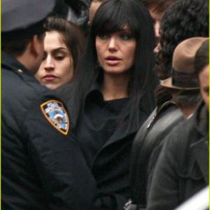 WITH ANGELINA JOLIE IN SALT CHOSEN BY DIRECTOR PHILLIP NOYCE TO BACK HER UP IN CROWD WEARING BROWN STETSON HAT.