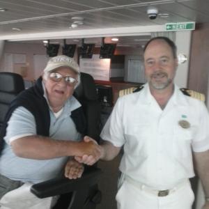 SITTING IN CAPTAINS CHAIR IN CONTROL WITH EL CAPITAN  ON SHIPS BRIDGE DECK OF THE BREAKAWAY S 6000 PASSENGERS AND CREW SHIP