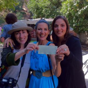Executive Producer Sharon A Fox in the middleon the set of ODD BRODSKY with Director Cindy Baer to the left and producer Thomai Hatsios at the right holding up the big check Sharon wrote towards the production