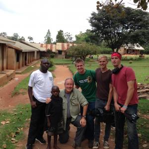 Road to Hope film crew posing with our leading documentary film character George at his school in Kakumiro Uganda