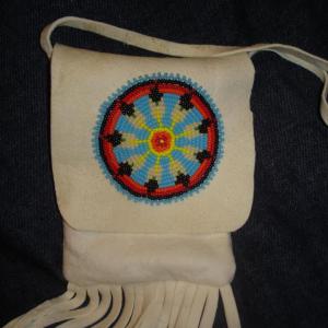 Deerskin beaded pouch - I first brain tanned the deer hide then used the hide to make this pouch and added beads. The threads do not go all the way thru the hide so they do not show on back.