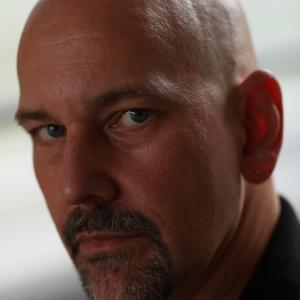 Dale Girard  stunt performer bald headshot