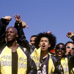 Kid (DEREK LUKE, front left) and Primo (RICK GONZALEZ, front right) and the rest of the Biker Boyz cheer on another racer.