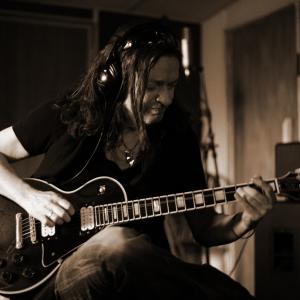 Dave recording with his Les Paul guitar in the studio