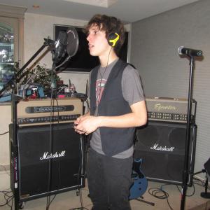 Cameron doing a studio recording one of his songs that he has written.