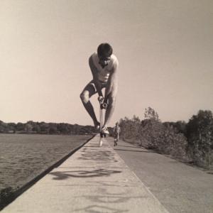 Vintage Greg doing a skateboard tail stand on top of the dam at White Rock Lake Dallas circa 1986