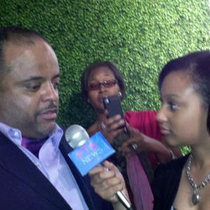 Aliyah at event with Roland Martin