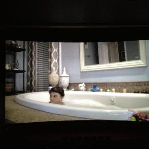 Aiden filming the infamous bathtub scene from Paranormal Activity 4