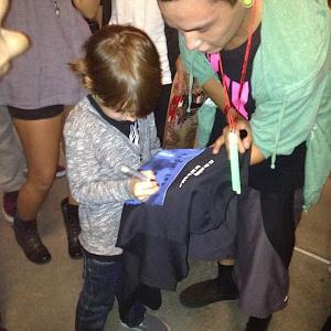 Aiden signing an autograph for a fan at the LA premiere of Paranormal Activity 4