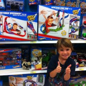 Aiden at the toy store seeing himself on the Hot Wheels toy box cover!