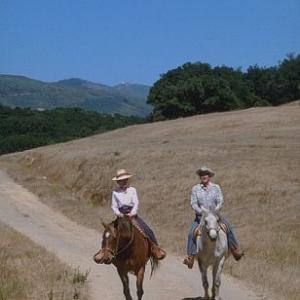 Ronald Reagan riding horses with wife Nancy