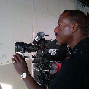 Director Bruce B Gordon making adjustments on an ArriSR2 Super 16mm film camera during a shoot in Los Angeles