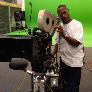 Director Bruce B. Gordon making adjustments for a Panavision 35mm film production.