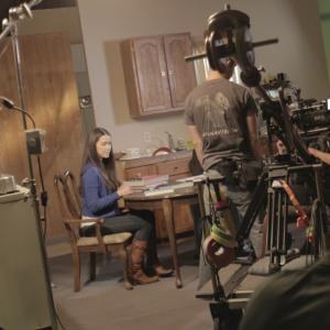 Actress Achara Kirk studies her lines while the crew sets up the equipment to get the next shots that director Bruce B Gordon blocked