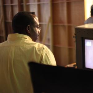 Director Bruce B. Gordon studying the shot in the monitor on the set of 