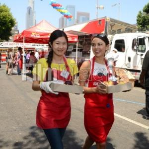 Actress Tina Q. Nguyen and actress Jarel Parrish (Pretty Little Liars) volunteers at the Los Angeles Mission's End of Summer Block Party on August 25, 2012
