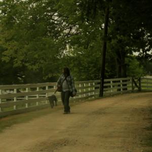 Jon and Jake traveling along a country road in a scene from Jakes Song