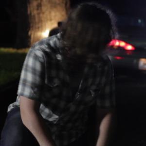 Jon Brewer sees the cops are coming as he leans over Jakes body in a scene from Jakes Song