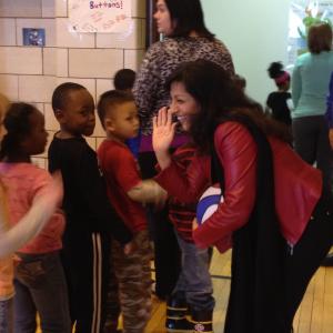 Gabriella greets children after assembly.