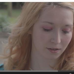 Rose in a snap shot from Fallen Florals Sunshine through the Rain music video