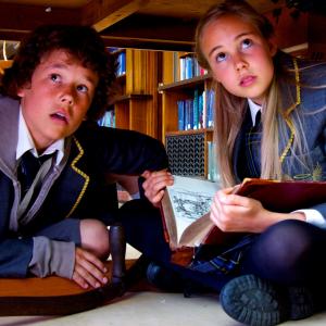 Ed Joel Barker and Grace Olivia Eastwood hide in Divinitys Great Library