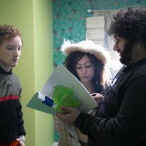 Michael William Hunter and Allisyn Ashley Arm talking to director Hooroo Jackson on the set of Aimy in a Cage