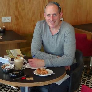 Lowell Joseph Gallin at his favorite cafe in Tel Aviv engaged in some of his favorite activities: drinking coffee, eating cake and doodling (with his new rapidograph