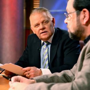 Host James B. Towle, on the set of Trigger Sports TV, on the American Trigger Sports Network, produced by Rose Marie Towel with guest panelist David Codrea.