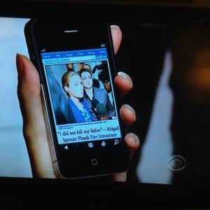 Lucy Liu holds cellphone with Kylies picture  scene from Elementary on CBS