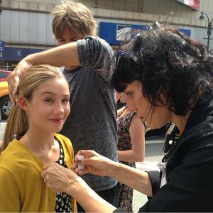 Kylie getting help from hair and wardrobe on the CBS set of 