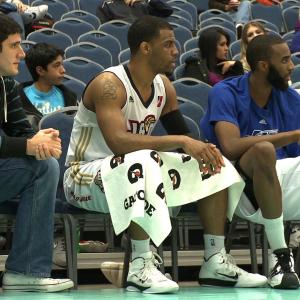 Jeff Camarra and Trey Johnson sit on the bench during the 2011 NBA DLeague Showcase