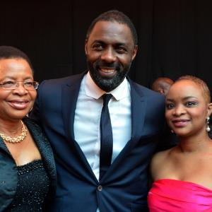 Nelson Mandela's wife Graca Machel (L), her daughter (R), and British actor Idris Elba, who plays the role of Nelson Mandela in the movie 