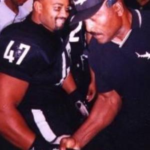 Dennis and NFL Hall of Famer, Jim Brown grip wrestle. -'Any Given Sunday' film