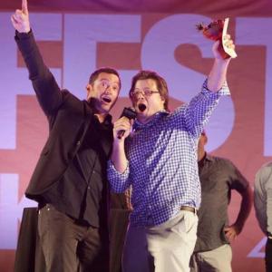 Hugh Jackman and 2012 Tropfest NY Winner Josh Leake sing on stage during his acceptance speech