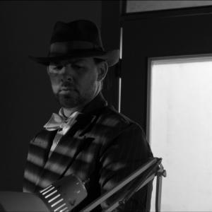 James R. Dempster as Detective Watson from the film noir 
