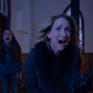 Still of Michelle Nolden and Amy Forsyth in A Christmas Horror Story 2015