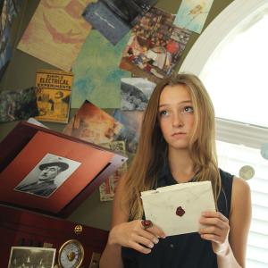 Natalie SaintMartin holds a letter from her farawayfriend in Of Far Away Places