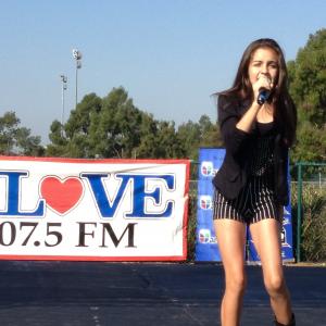 Samantha singing for Univision and K-LOVE (radio station) at an education festival.