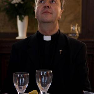 Still of JeanNoel in the feature LE DERNIER WEEK END role of a humanist Priest