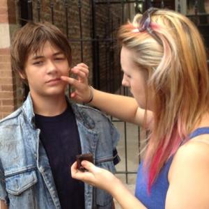 Jacob M Williams getting makeup touched up by artist Sarah Sharp