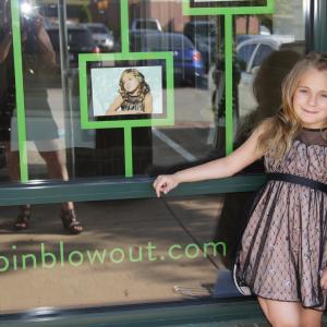 This is Tatum Jade outside of The Hair Bart store where she is featured on the store front graphics