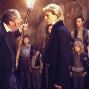 Nicholas Nickleby (CHARLIE HUNNAM) tries to protect the Dotheboys Hall orphans from Wackford Squeers (JIM BROADBENT)