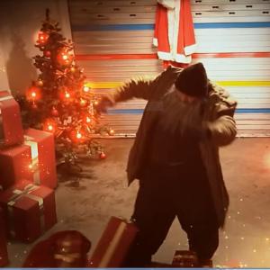 Still of Dean Dawson as the Real Santa as he kicks the presents for a Gift Topping commercial.