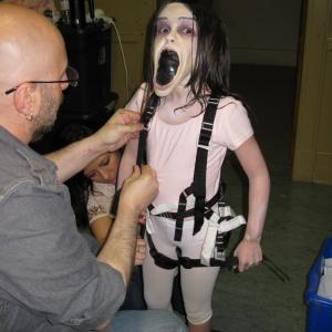 Dalila Bela putting the harness for one of her scenes on Grave Encounters 2